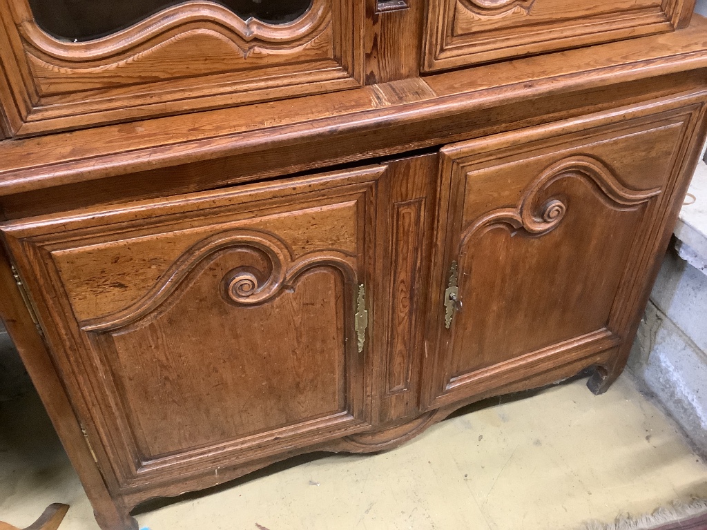 A 19th century French stained pine vitrine, with two glazed doors over panelled doors, width 133cm